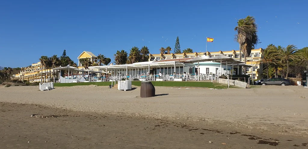 Elviria beach, East Marbella, with the beach club and beachfront apartments behind